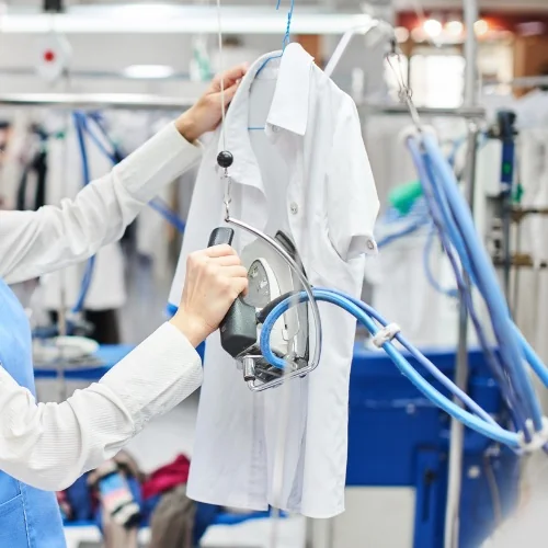 A white shirt being professionally steam pressed
